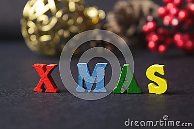 The concept of a New year, xmas. The word from multicolored letters on wooden Christmas background with gifts, pine cones, Christm Stock Photo