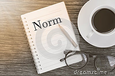 Concept Norm message on notebook with glasses, pencil and coffee Stock Photo