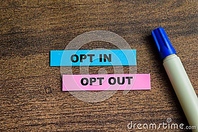 Concept of Opt in and Opt Out write on sticky notes isolated on Wooden Table Stock Photo