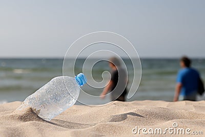 Abandoned PET plastic water bottle. The concept of littering the natural environment. Ecological damage on the beach Stock Photo