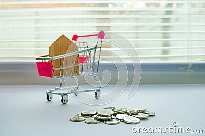 The concept of personal spending, shopping and finance. House, Trolley, Ladder Up on White Background, Money, Finance, Tax, Profit Stock Photo
