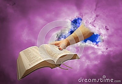 Divine hand of god giving holy bible to mankind Stock Photo