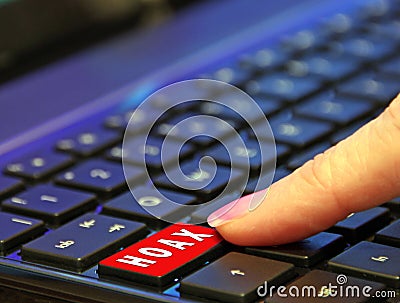 Finger pressing pushing down red hoax scam computer keyboard button word Stock Photo