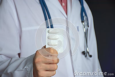 Concept photo for the treatment of constipation, diseases of the rectum or vagina in women. The doctor holds in his hand a sealed Stock Photo