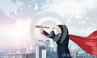 Concept of power and sucess with businesswoman superhero in big city Stock Photo