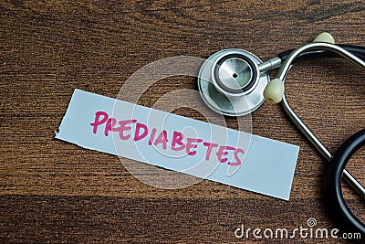 Concept of Prediabetes write on sticky notes isolated on Wooden Table Stock Photo