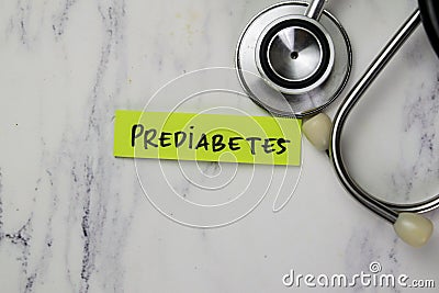 Concept of Prediabetes write on sticky notes with stethoscope isolated on Wooden Table Stock Photo