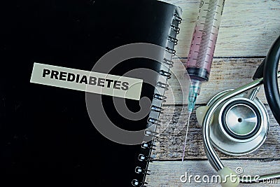 Concept of Prediabetes write on sticky notes with stethoscope isolated on Wooden Table Stock Photo