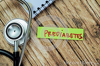 Concept of Prediabetes write on sticky notes with stethoscope isolated on Wooden Table Stock Photo