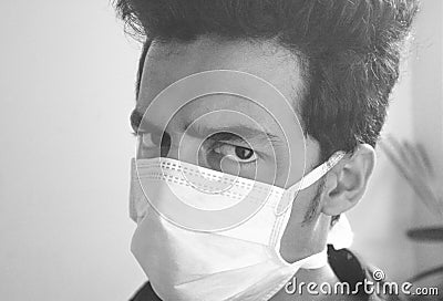 The concept of preventing the spread of the epidemic corona virus. man wearing face mask and looking at camera., black and white Stock Photo