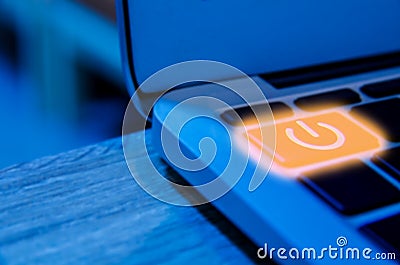 Concept of Programmer need to take a break or rest, laptop backlit keyboard detail with power Button Stock Photo