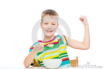 concept - proper nutrition, a strong healthy boy shows biceps Stock Photo