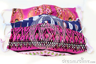 Colorful DIY fabric cotton protective masks on white background. Stock Photo