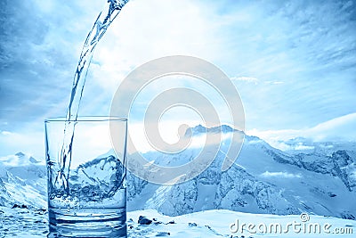 Concept purity of blue water in transparent glass over winter la Stock Photo