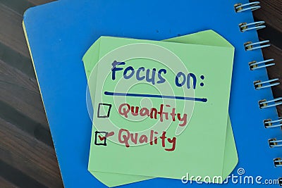 Concept of Quality is Important and Focus on Quality write on sticky notes isolated on Wooden Table Stock Photo