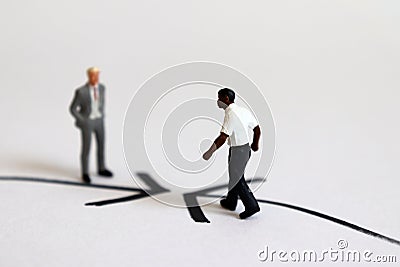 The concept of racial confrontation. Miniature people. Stock Photo