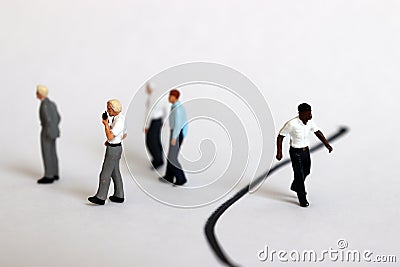 The concept of racial discrimination within the organization. Miniature people. Stock Photo