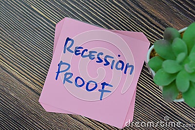 Concept of Recession Proof write on sticky notes isolated on Wooden Table Stock Photo