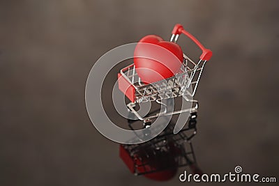 A red heart lies in a shopping cart Stock Photo