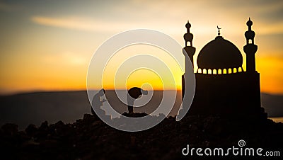 Concept of religion Islam. Silhouette of man praying on the background of a mosque at sunset Stock Photo