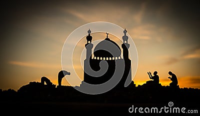 Concept of religion Islam. Silhouette of man praying on the background of a mosque at sunset Stock Photo