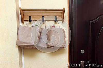 The concept of safe delivery in close-up. paper bags with food on handle of door Stock Photo
