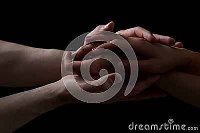 Concept of salvation. Hands of two people rescue, help. Helping hand, support. Isolated arm on black, charity. Devoted Stock Photo