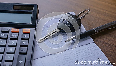 The concept of saving money. Saving money to buy a car and repairs.Miniature car model,calculatorand Financial statement with Stock Photo
