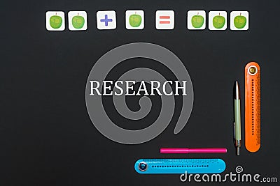 Black art table with stationery supplies with text research on blackboard Stock Photo