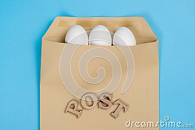 The concept of secure courier service, reliable postal company. Abstract image of eggs in an envelope and the word mail, post. Stock Photo