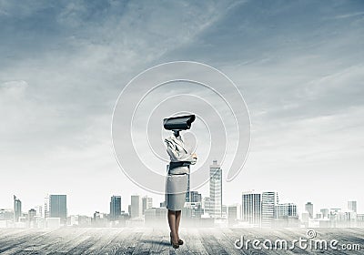 Concept of security and privacy protection with camera headed woman Stock Photo