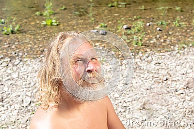 The concept of self-knowledge, communication with God, the search for yourself. elderly man with pensive view on shore Stock Photo