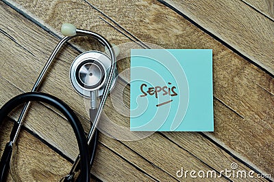 Concept of Sepsis write on sticky notes with stethoscope isolated on Wooden Table Stock Photo