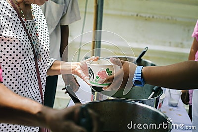 Concept serving free food to the poor : Free food, Using leftovers to feed the hungry : Food concept of hope : Food donation in Stock Photo