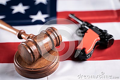 Concept showing of US or American gun laws with Judge gavel and Vintage Pistol on American flag Stock Photo