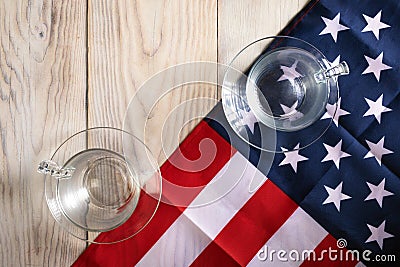 concept of single candidate winning an American election. One glass on American flag, other on table opposite Stock Photo