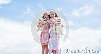 concept of sisterhood and friendship. family bonding time. best friends hold bear toy. two sisters with teddy bear Stock Photo