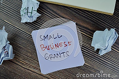 Concept of Small Business Grants write on sticky notes isolated on Wooden Table Stock Photo