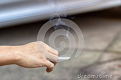 The concept of smoking cessation with male hands is carrying smoke cigarettes drugs, which are harmful to people around and Stock Photo