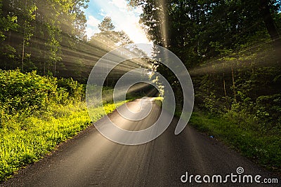 Concept of someone walking a tough road in life, but the light, happiness and salvation is just ahead on the next curve. Stock Photo