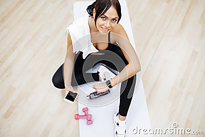 Concept of sport and healthy lifestyle. Cute brunette working out at a gym Stock Photo