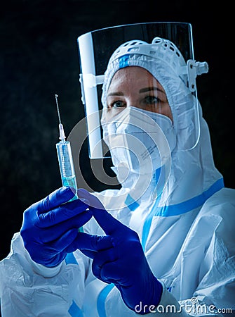 Detail closeup of syringe needle and ampoule , nurse taking injection shot,hands in blue protective gloves holding Stock Photo