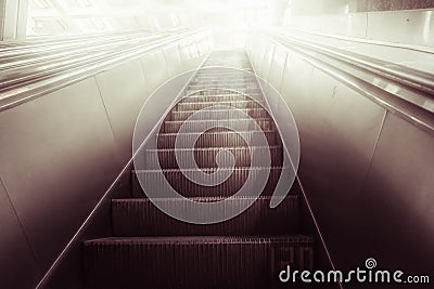 Concept of success in business, moving up the career path. Underground Escalator Conveor in Subway Stock Photo