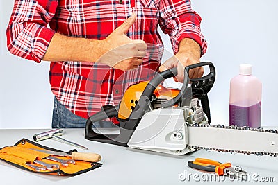 Concept success in small business. Repair of chainsaws,gasoline powered tools Stock Photo