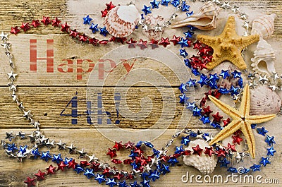 Concept for summer United States holiday of fourth of July on the beach with shells, starfish and sand with message Stock Photo