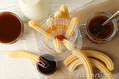 Concept of sweet lunch with churros on white wooden background Stock Photo