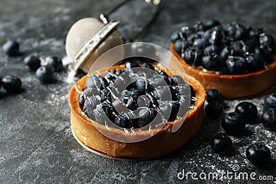 Concept of tasty lunch with blueberry pies on dark background Stock Photo