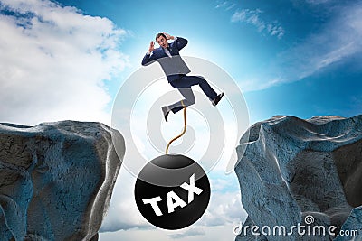 Concept of tax burden with businessman over chasm Stock Photo