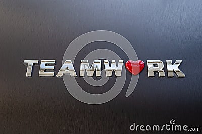 Concept of teamwork, cooperation, working and relationship. Word teamwork spelled on aluminium background Stock Photo