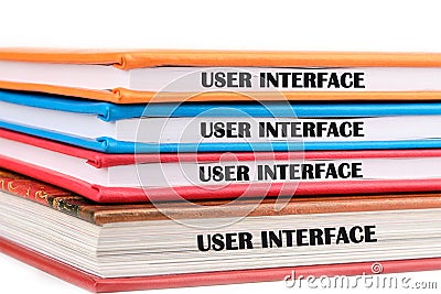 The concept of technology and development. Phrase, word, text USER INTERFACE on the ends of the notebooks assembled in a Stock Photo